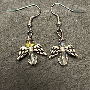 Handcrafted silver tone angel earrings with iridecent stones.